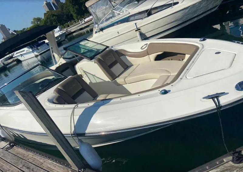 Slide: The Image of 2013 Sea Ray 300 SLX boat docked in marina, featuring sleek design and spacious seating. - 17