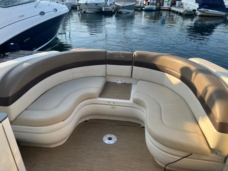 Slide: The Image of 2013 Sea Ray 300 SLX boat with beige seating at a marina. - 2