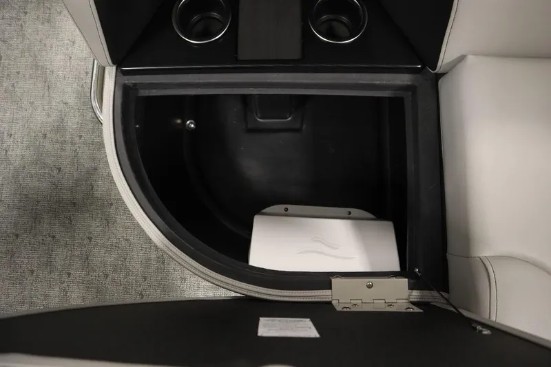 Slide: The Image of Storage compartment in 2025 Trifecta 22TRFC LE 2.75 boat, featuring cup holders and sleek design. - 32