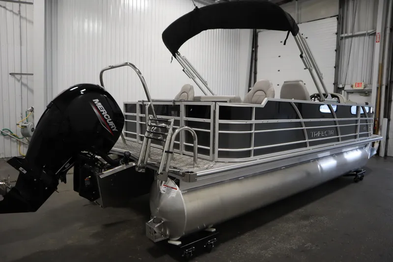 Slide: The Image of 2025 Trifecta 22TRFC LE 2.75 pontoon boat in a showroom, featuring sleek design and modern amenities. - 4