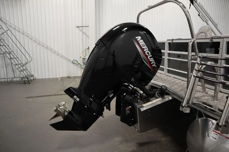 Slide: The Image of 2025 Trifecta 22TRFC LE 2.75 pontoon boat with Mercury outboard motor in a garage. - 40