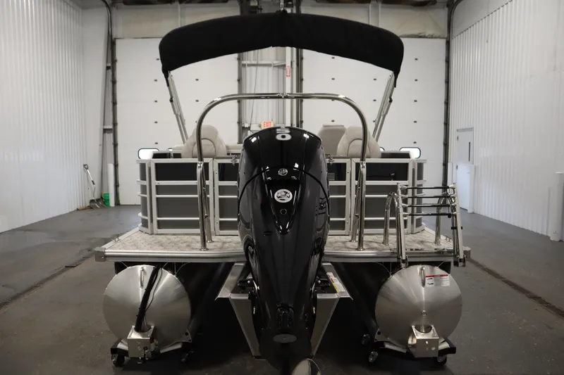 Slide: The Image of 2025 Trifecta 22TRFC LE 2.75 pontoon boat in a showroom, front view. - 5