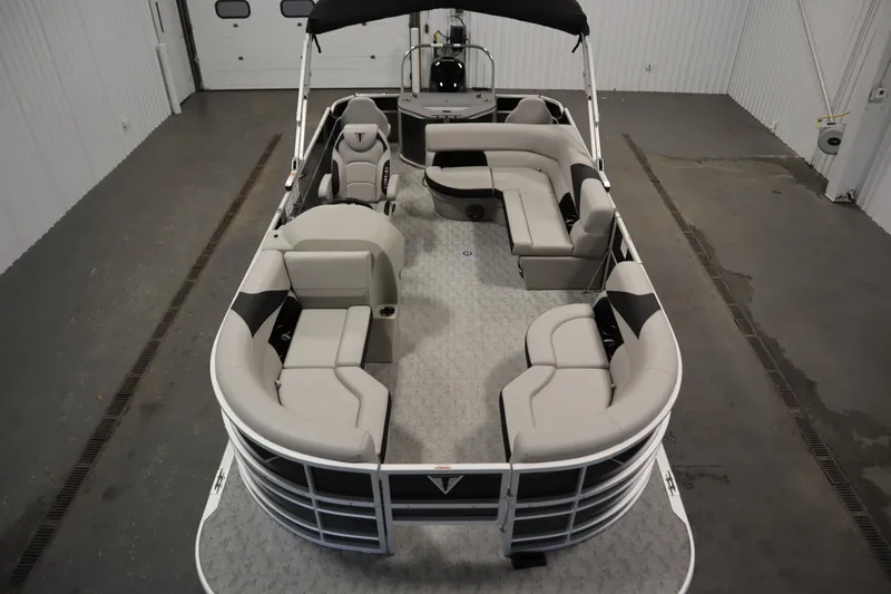 Slide: The Image of 2025 Trifecta 22TRFC LE 2.75 pontoon boat in a showroom setting. - 7