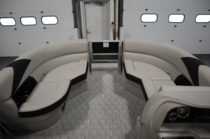 Slide: The Image of 2025 Trifecta 22TRFC LE 2.75 pontoon boat with Mercury outboard in a garage setting. - 9