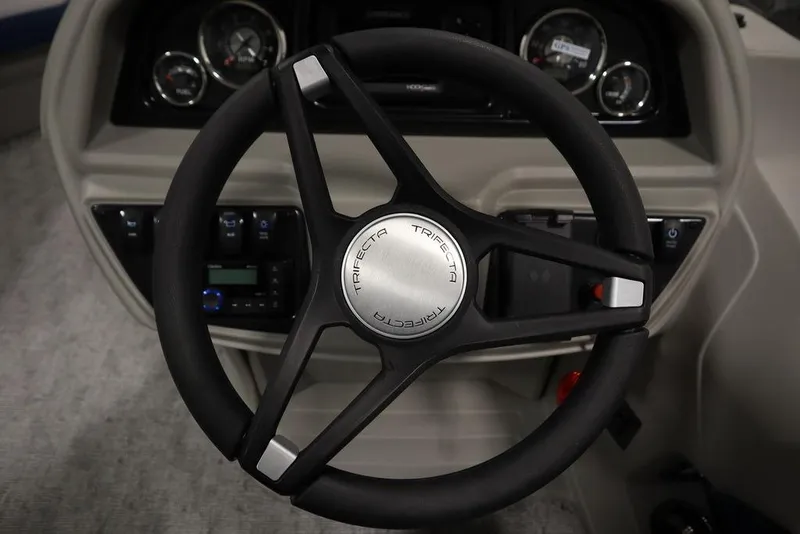 Slide: The Image of Steering wheel of 2025 Trifecta 22RF LE 2.75 boat, featuring modern dashboard controls. - 24