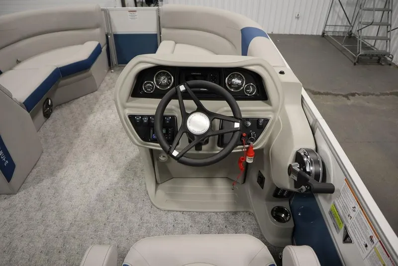 Slide: The Image of 2025 Trifecta 22RF LE 2.75 boat interior with steering wheel and seating. - 25