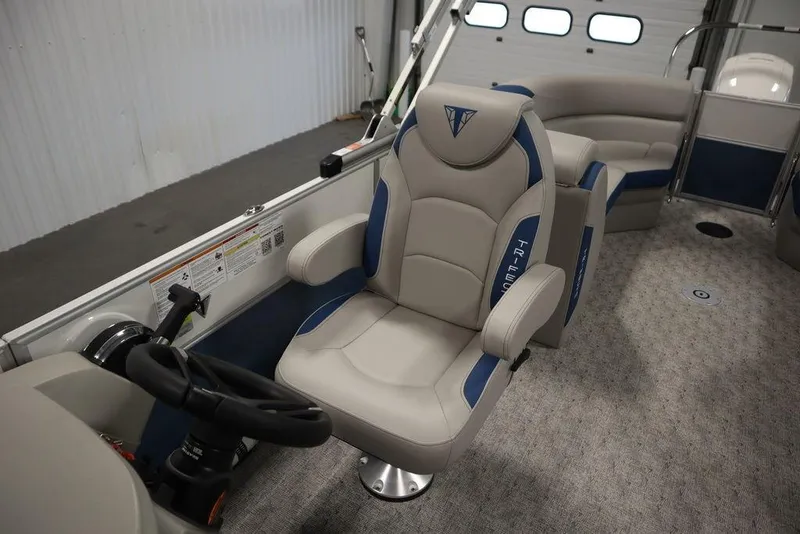 Slide: The Image of 2025 Trifecta 22RF LE 2.75 boat interior with plush captain's chair and steering wheel. - 33