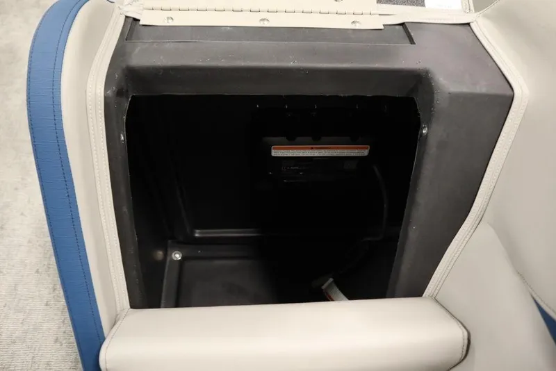 Slide: The Image of Storage compartment in 2025 Trifecta 22RF LE 2.75 boat, featuring blue and white upholstery. - 40