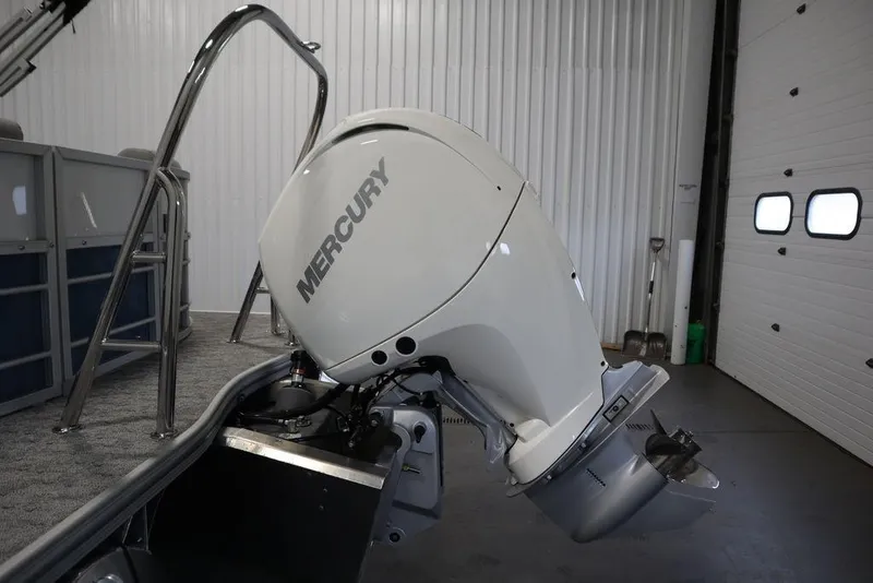 Slide: The Image of 2025 Trifecta 22RF LE 2.75 boat with Mercury outboard motor in a garage. - 44