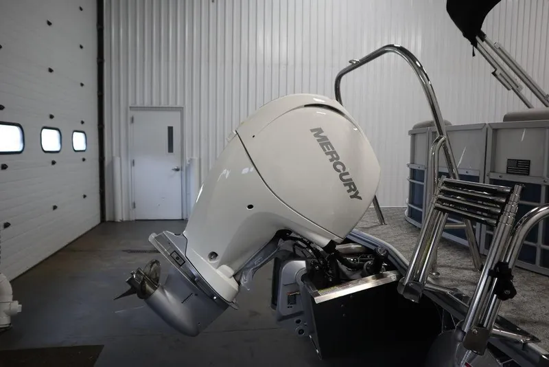 Slide: The Image of 2025 Trifecta 22RF LE 2.75 boat with Mercury outboard motor in a garage. - 45