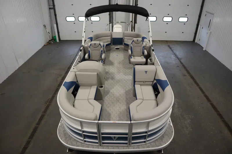 Slide: The Image of 2025 Trifecta 22RF LE 2.75 pontoon boat in a garage setting. - 7