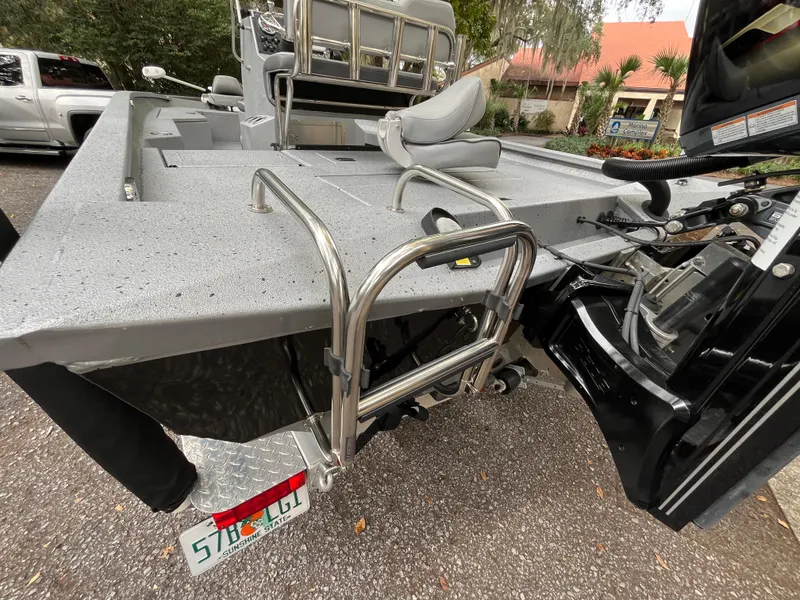 Slide: The Image of 2022 Xpress H22 boat with ladder and seating, parked outdoors. - 14