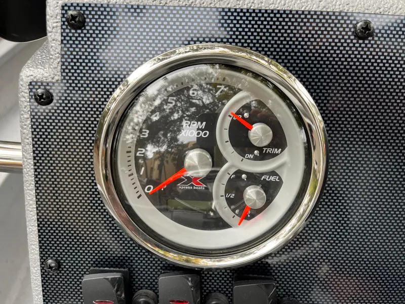 Slide: The Image of Dashboard of 2022 Xpress H22 boat with RPM, trim, and fuel gauges. - 18