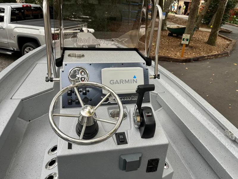 Slide: The Image of 2022 Xpress H22 boat dashboard with Garmin navigation system and steering wheel. - 4