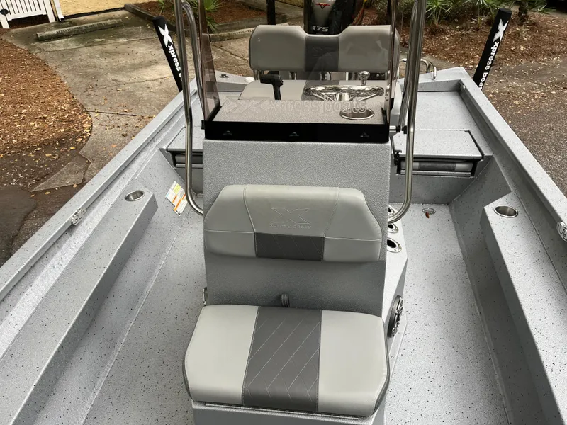 Slide: The Image of 2022 Xpress H22 boat interior with gray seating and console. - 5