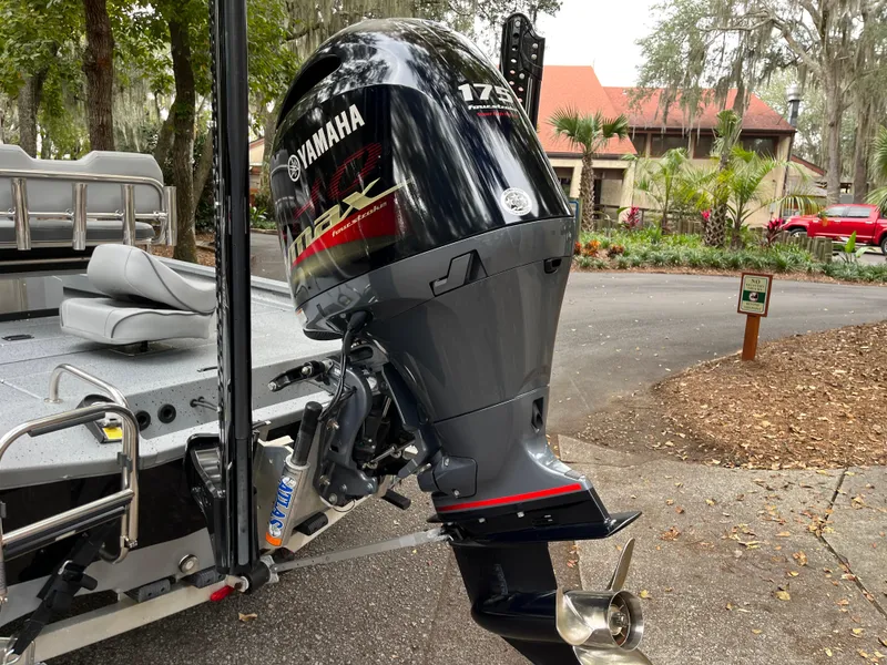 Slide: The Image of 2022 Xpress H22 boat with Yamaha 175 HP outboard motor, parked outdoors. - 7