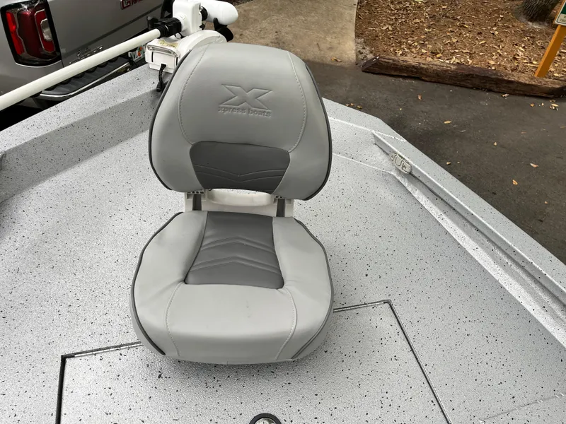Slide: The Image of 2022 Xpress H22 boat seat, gray upholstery, on speckled deck. - 9