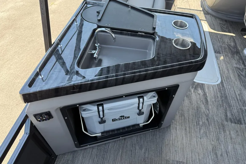 Slide: The Image of 2025 Avalon 2385 LSZ Elite Windshield boat sink and cooler setup. - 11