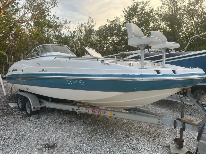 Slide: The Image of 2007 Hurricane SunDeck 237 OB boat on trailer, parked outdoors. - 0