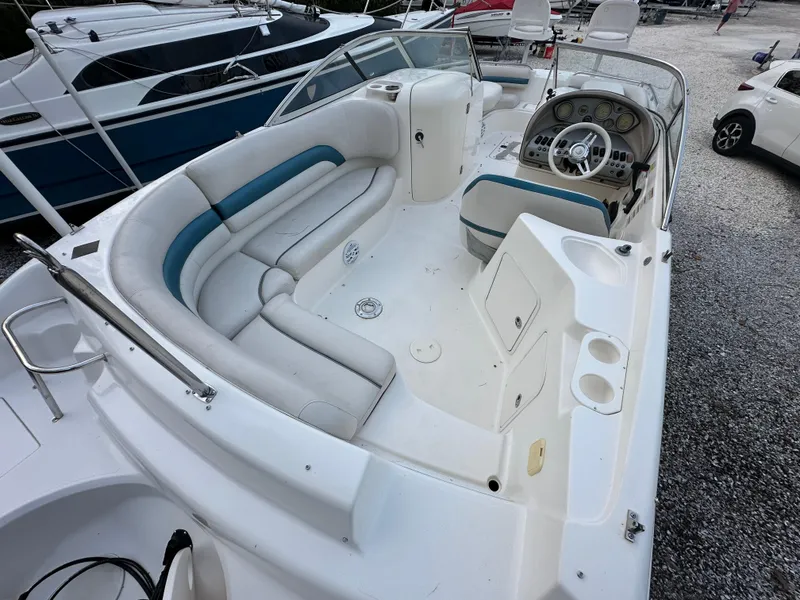 Slide: The Image of 2007 Hurricane SunDeck 237 OB boat with spacious seating and modern dashboard. - 10