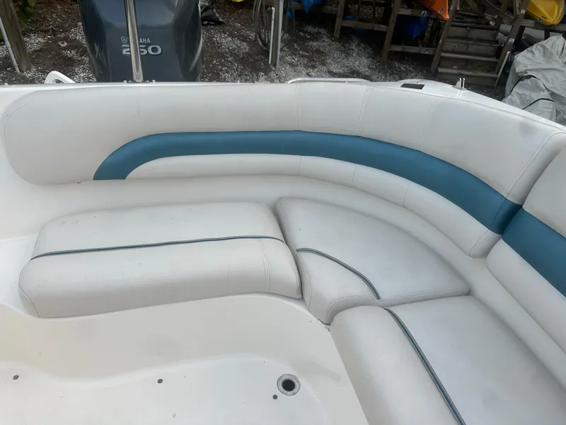 Slide: The Image of 2007 Hurricane SunDeck 237 OB boat interior with white and blue seating. - 12