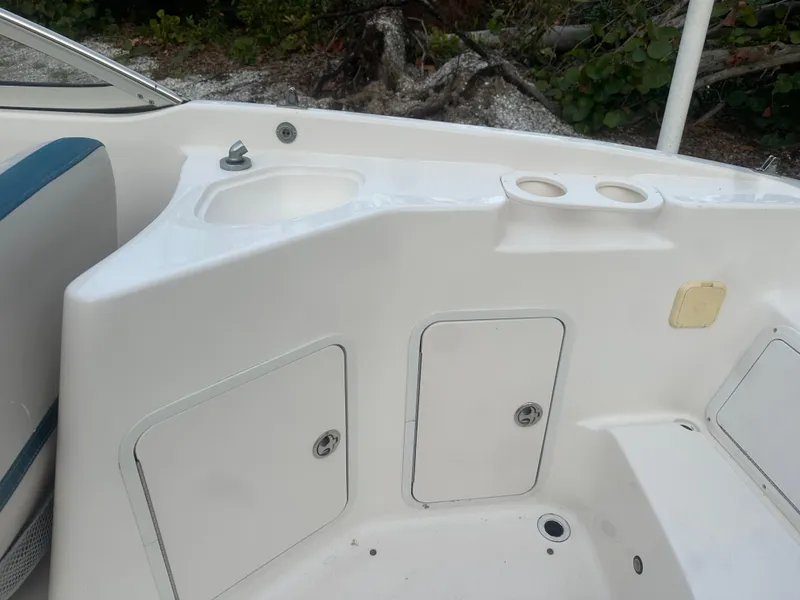 Slide: The Image of 2007 Hurricane SunDeck 237 OB boat interior with storage compartments and cup holders. - 13