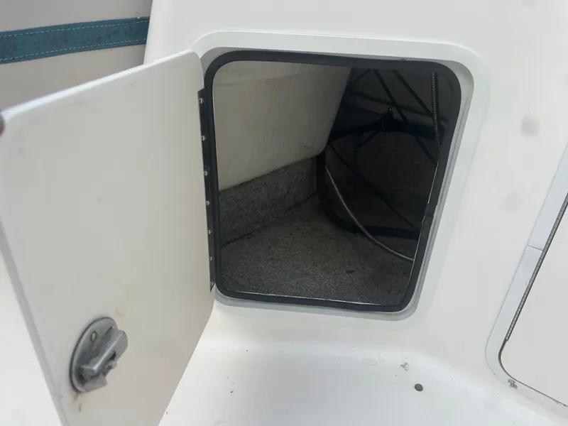 Slide: The Image of Open storage compartment on a 2007 Hurricane SunDeck 237 OB boat. - 14
