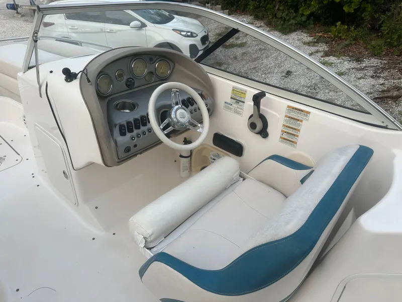 Slide: The Image of 2007 Hurricane SunDeck 237 OB boat interior with steering wheel and dashboard controls. - 16