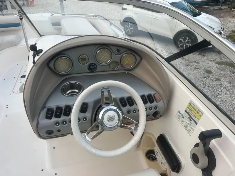 Slide: The Image of 2007 Hurricane SunDeck 237 OB boat dashboard with steering wheel and control panel. - 20