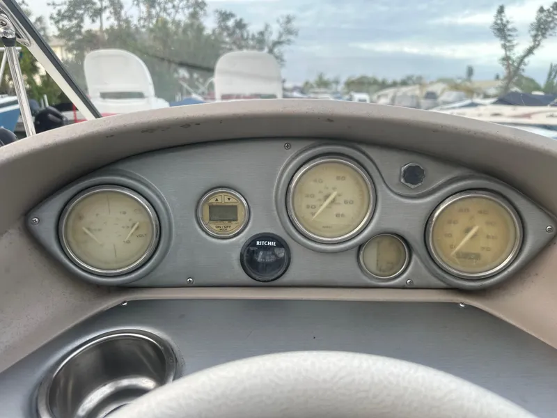 Slide: The Image of Dashboard of a 2007 Hurricane SunDeck 237 OB boat with gauges and controls. - 21