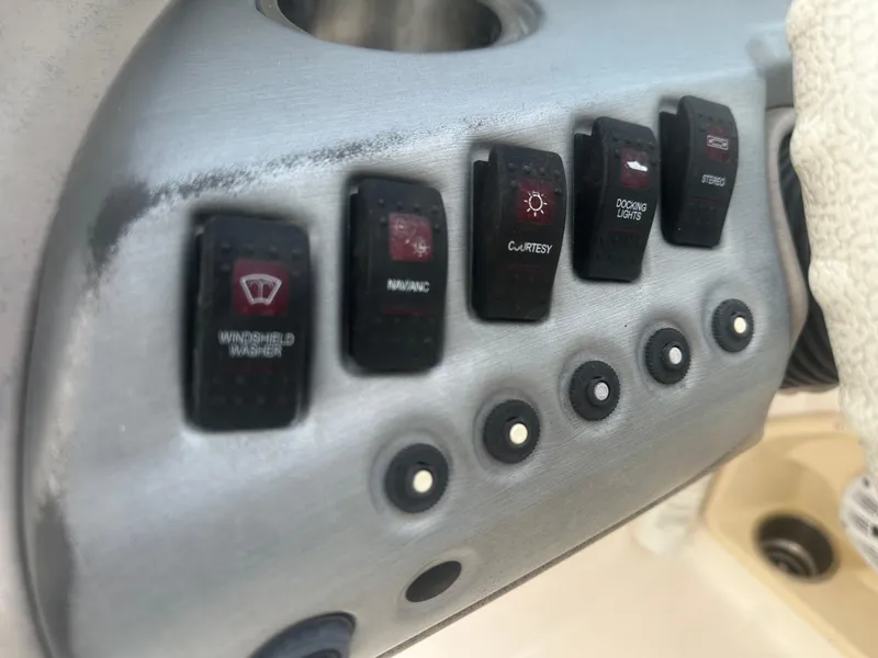 Slide: The Image of Control panel of a 2007 Hurricane SunDeck 237 OB boat with various switches. - 22