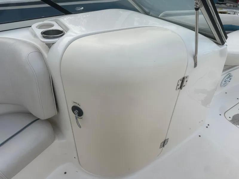 Slide: The Image of 2007 Hurricane SunDeck 237 OB boat interior with white seating and storage compartment. - 26