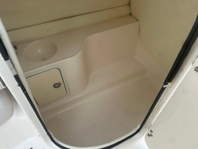 Slide: The Image of 2007 Hurricane SunDeck 237 OB boat interior with sink and storage compartment. - 27
