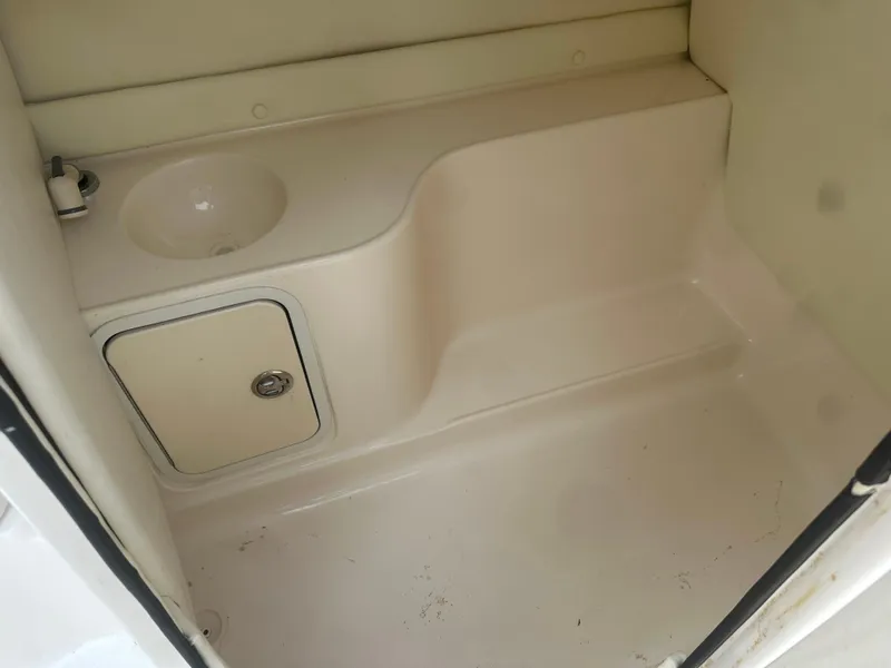 Slide: The Image of 2007 Hurricane SunDeck 237 OB boat interior with sink and storage compartment. - 28