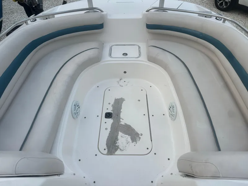 Slide: The Image of 2007 Hurricane SunDeck 237 OB boat interior with white seating and blue accents. - 30
