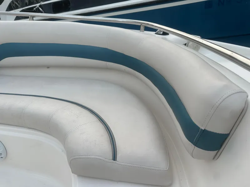 Slide: The Image of 2007 Hurricane SunDeck 237 OB boat seating with white and blue upholstery. - 31