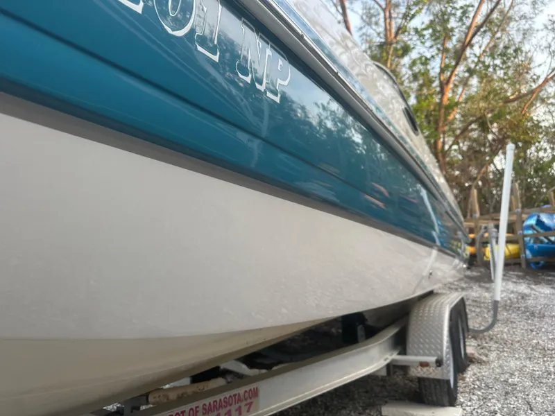Slide: The Image of 2007 Hurricane SunDeck 237 OB boat on trailer, side view, parked outdoors. - 4