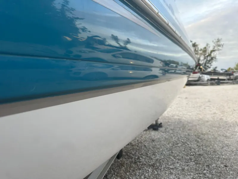 Slide: The Image of Close-up of a 2007 Hurricane SunDeck 237 OB boat hull in a gravel lot. - 6