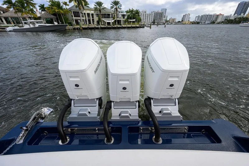 Slide: The Image of 2022 Valhalla V-46 Center Console with triple Mercury outboard engines on water. - 11