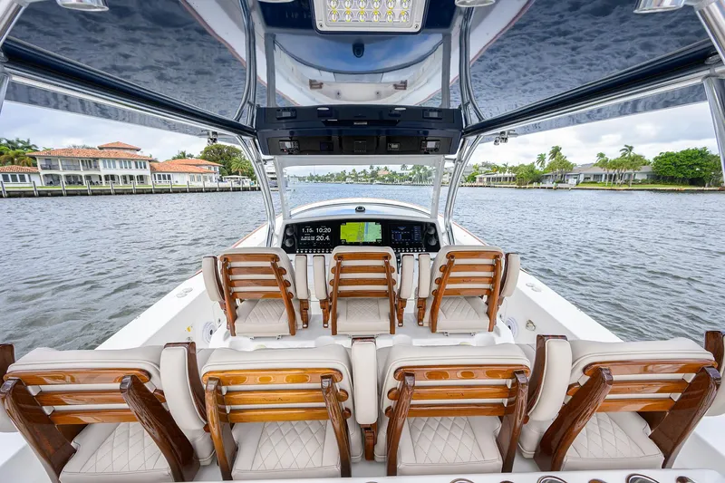 Slide: The Image of 2022 Valhalla V-46 Center Console boat interior with luxurious seating and advanced controls. - 12