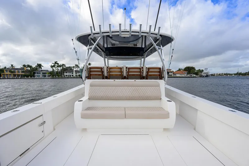 Slide: The Image of 2022 Valhalla V-46 Center Console boat with spacious seating on a calm waterway. - 2