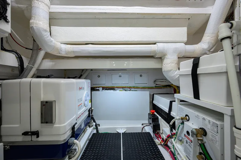 Slide: The Image of Engine room of 2022 Valhalla V-46 Center Console with equipment and piping. - 24