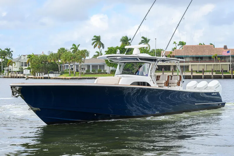 Slide: The Image of 2022 Valhalla V-46 Center Console boat cruising on a calm waterway. - 29