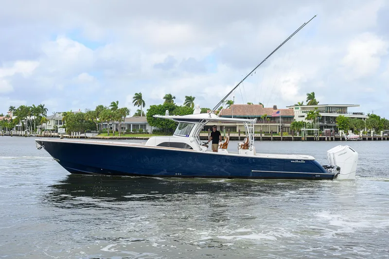 Slide: The Image of 2022 Valhalla Boatworks V-46 Center Console on water, sleek design, coastal background. - 30