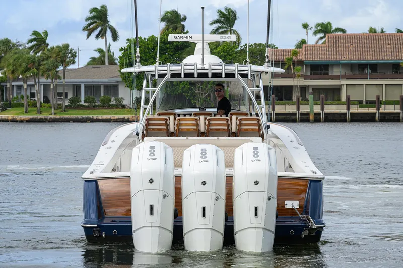 Slide: The Image of 2022 Valhalla V-46 Center Console boat with four powerful engines on a calm waterway. - 32