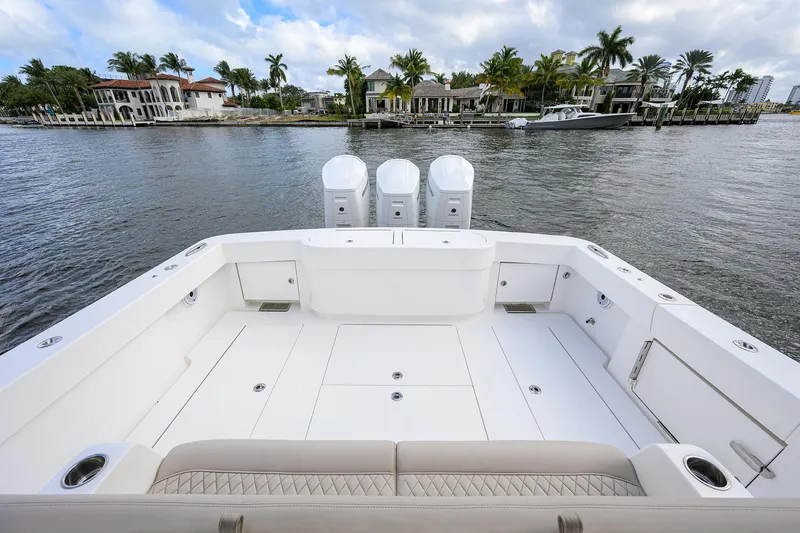 Slide: The Image of 2022 Valhalla V-46 Center Console boat with spacious deck and triple engines on a scenic waterway. - 4