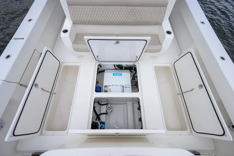Slide: The Image of 2022 Valhalla V-46 Center Console boat storage compartments open on deck. - 5