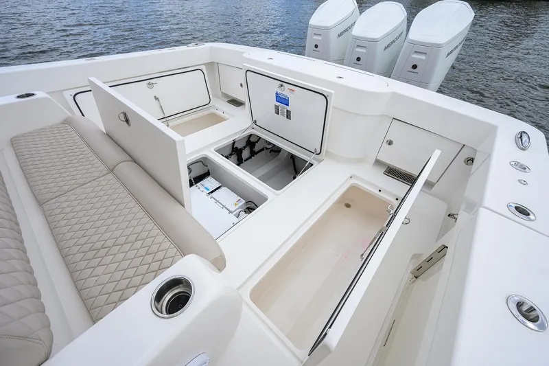 Slide: The Image of 2022 Valhalla V-46 Center Console boat interior with storage compartments and seating. - 6
