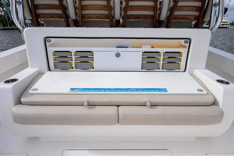 Slide: The Image of 2022 Valhalla V-46 Center Console boat with organized storage compartments and cushioned seating. - 9