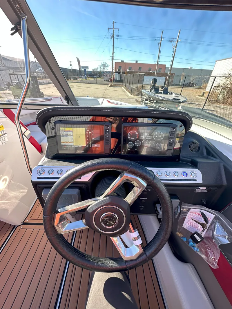 Slide: The Image of 2025 Crownline 240 SS boat dashboard with modern controls and steering wheel. - 13